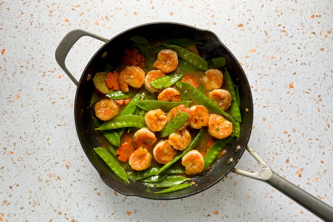 Shrimp stir-fry in a frying pan