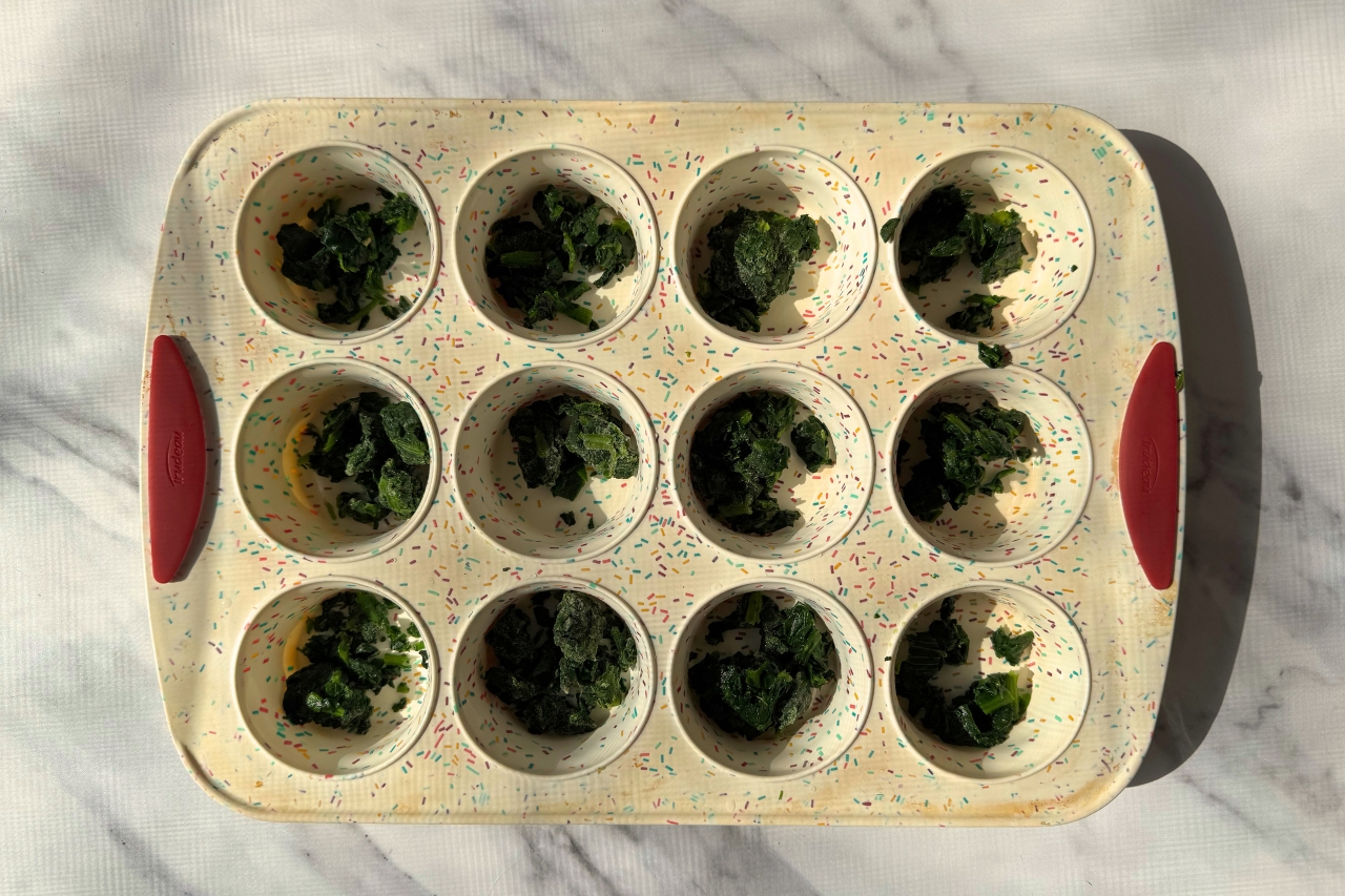 Frozen spinach in a muffin tray.