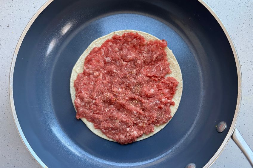 smash gyro taco meat side up in a pan