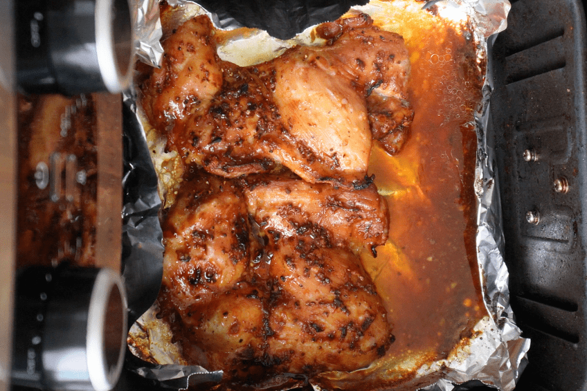 Marinated chicken in an air fryer basket
