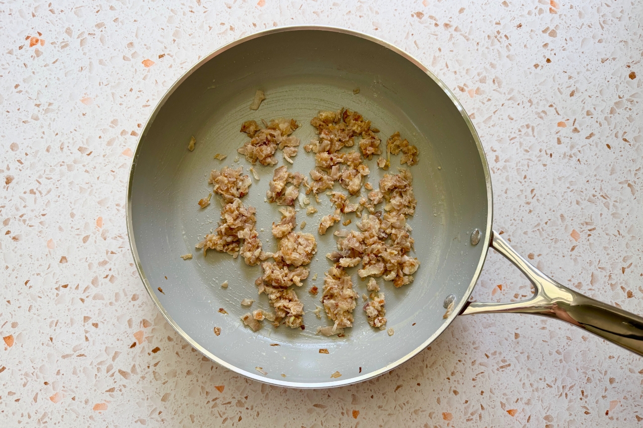 Shallots coated in flour in a pan