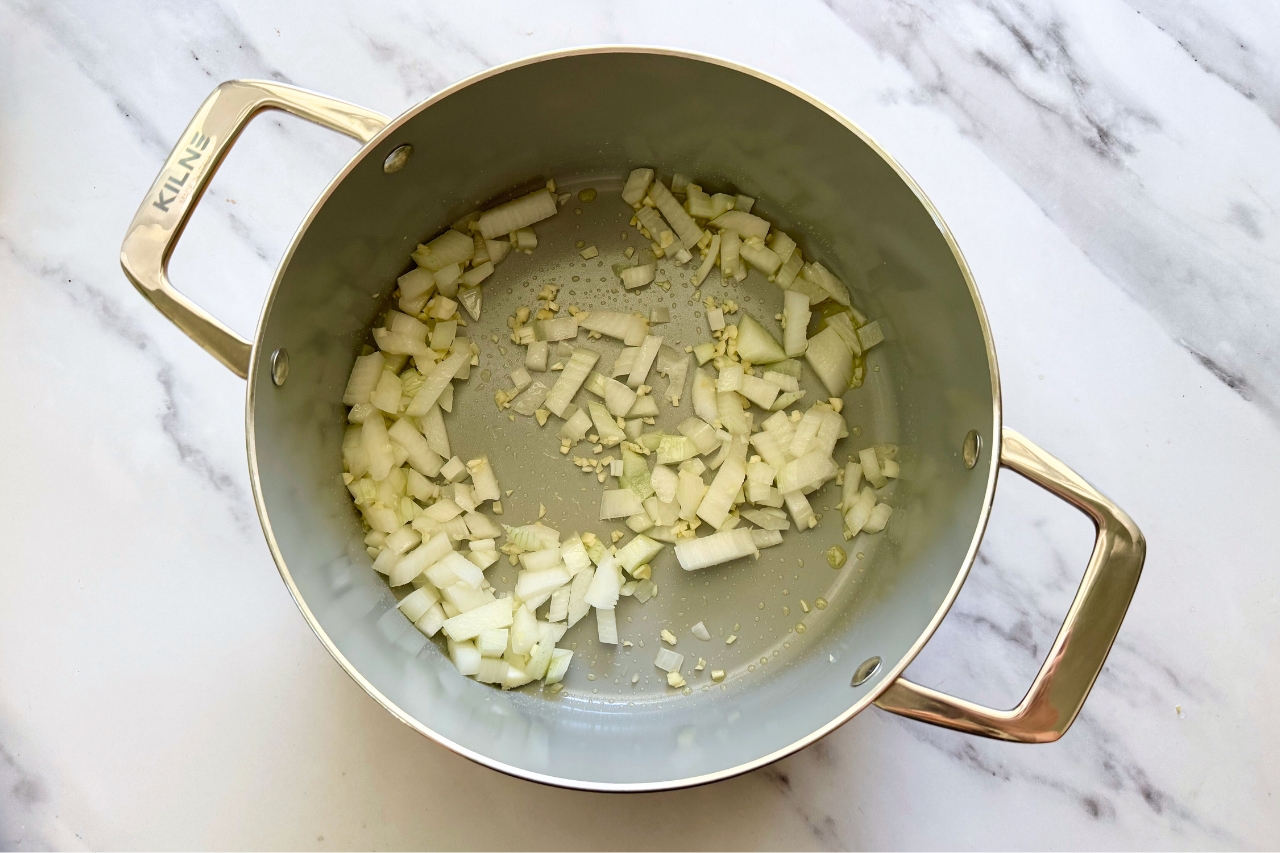Onions and garlic in pot for lasagna soup